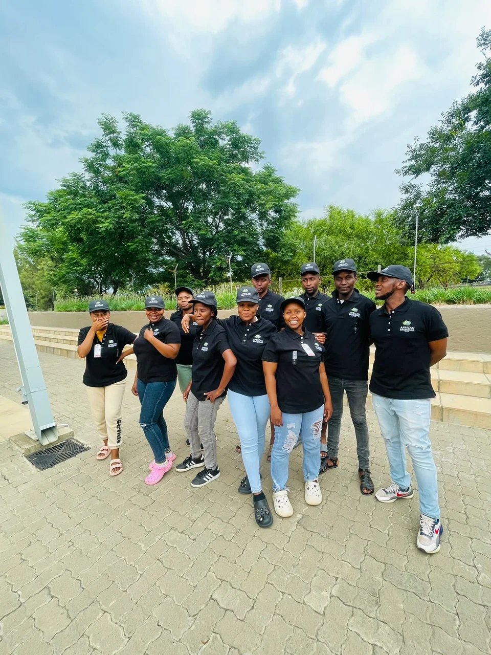A cohort of young agripreneurs in EARN shirts, standing together outside the training centre